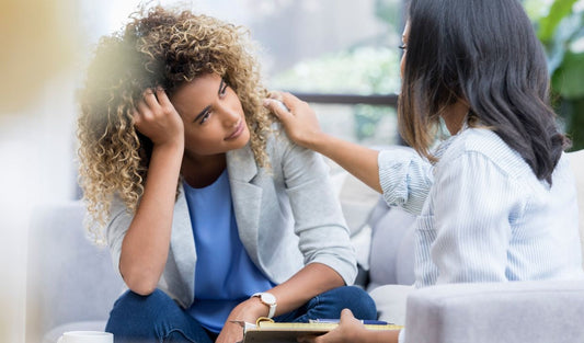 Woman comforting another woman during a counseling or mental health support session