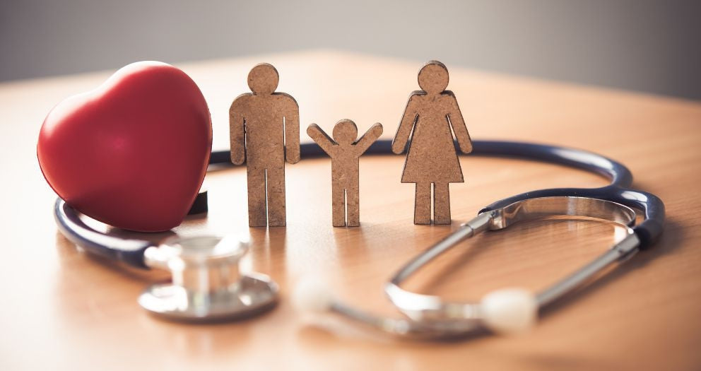 Stethoscope, red heart, and wooden family figures symbolizing healthcare and medical supplies