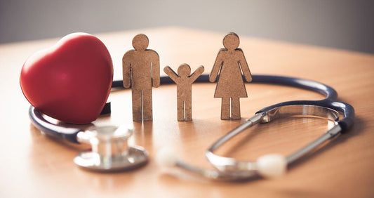 Stethoscope, red heart, and wooden family figures symbolizing healthcare and medical supplies