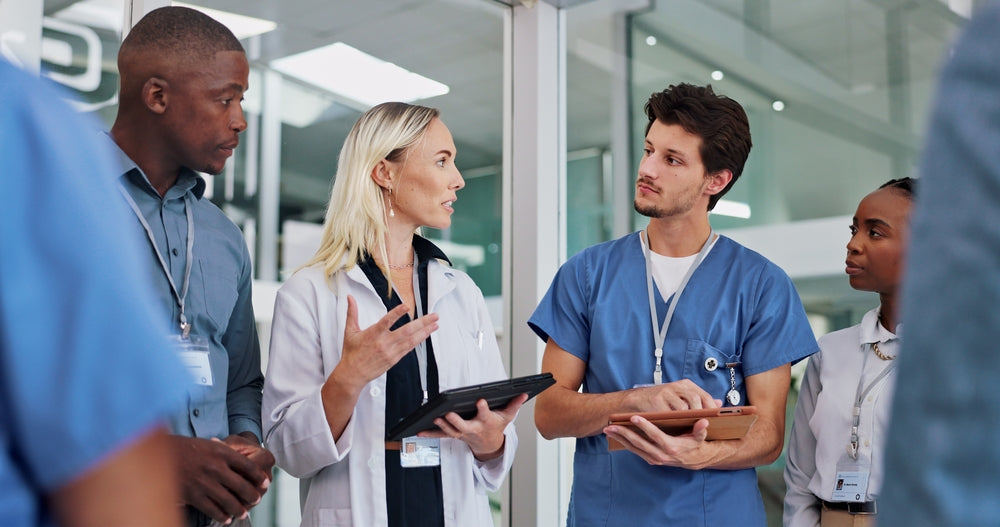 Medical professionals discussing supplies in a modern UK clinic setting