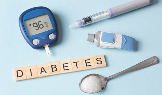 Diabetes awareness with glucometer, insulin pen, lancet device, sugar, and DIABETES text on blue background.