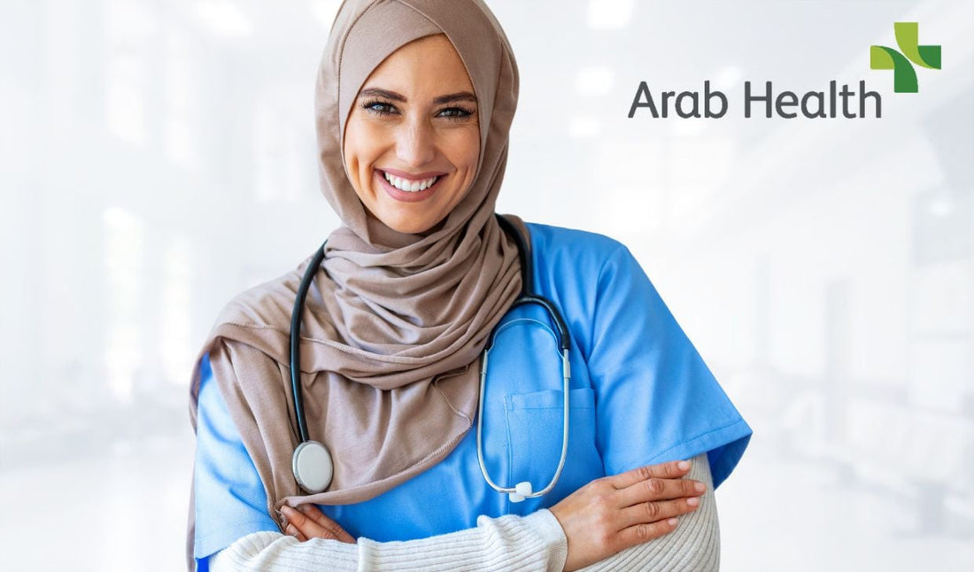 Smiling female healthcare worker in blue scrubs and hijab with stethoscope in hospital setting