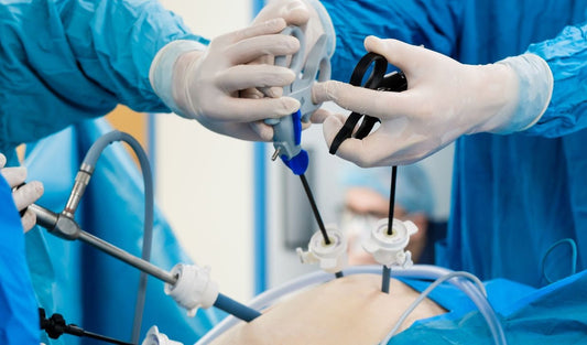 Surgeons performing laparoscopic surgery using medical instruments in an operating room