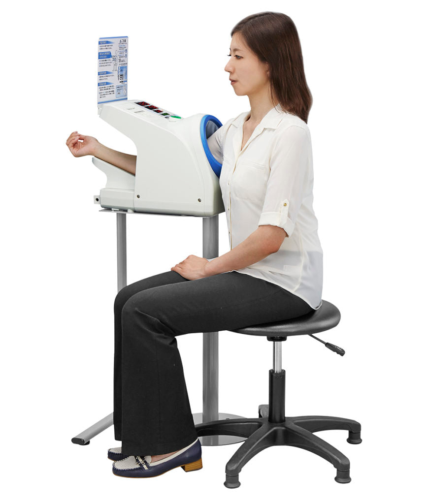 A&D Medical TM-2657P waiting room upper arm blood pressure monitor with cuff and digital display on a white background.