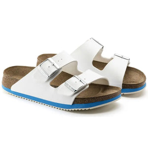 White double strap sandals with buckles, cork footbed, and blue sole for comfort.