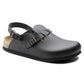 Black soft footbed clog with adjustable slingback strap and cork sole on white background