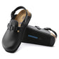 Black closed-toe clogs with adjustable strap, soft footbed, and textured sole