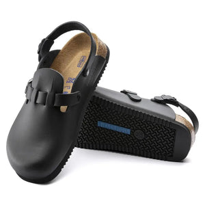 Black closed-toe clogs with adjustable strap, soft footbed, and textured sole