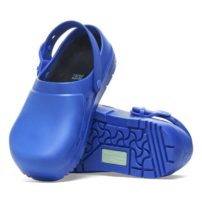 Blue slip-resistant clogs with closed toe and adjustable strap, designed for medical use.
