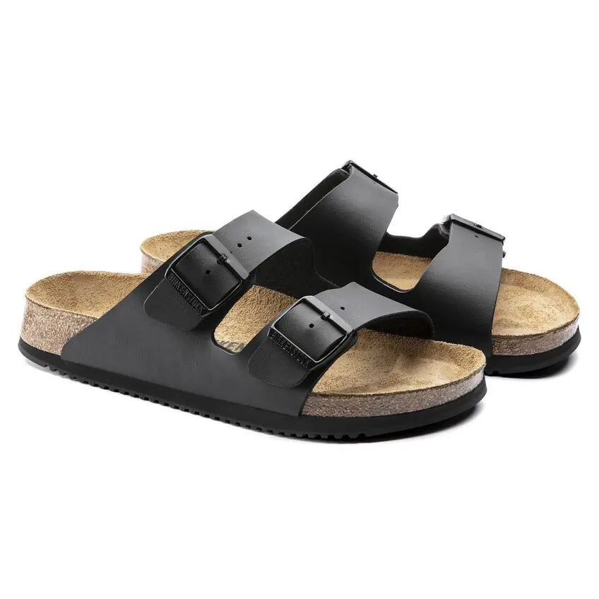 Black two-strap sandals with cork footbed and adjustable buckles on a white background