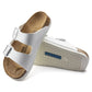 White double strap sandals with buckles, cork footbed, and non-slip sole, close-up view
