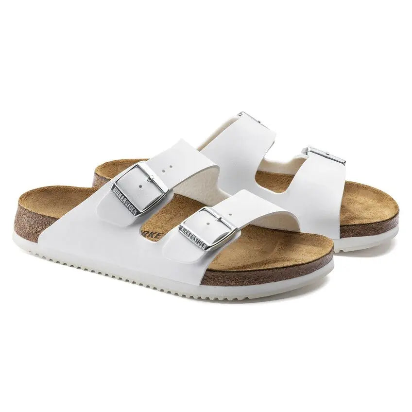 White double strap sandals with adjustable buckles and cork footbed on white background