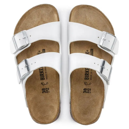 White leather double strap sandals with buckles and cork footbed, top view