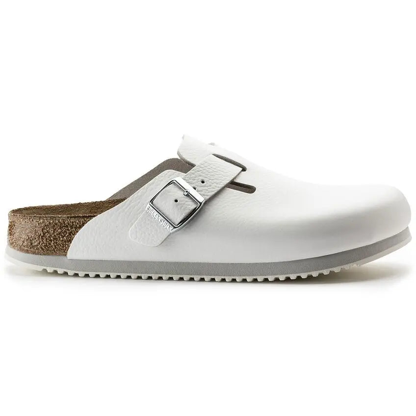 White slip-on medical clog with buckle, closed toe and non-slip sole, side view