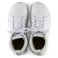 Pair of white leather lace-up sneakers viewed from above on a plain background