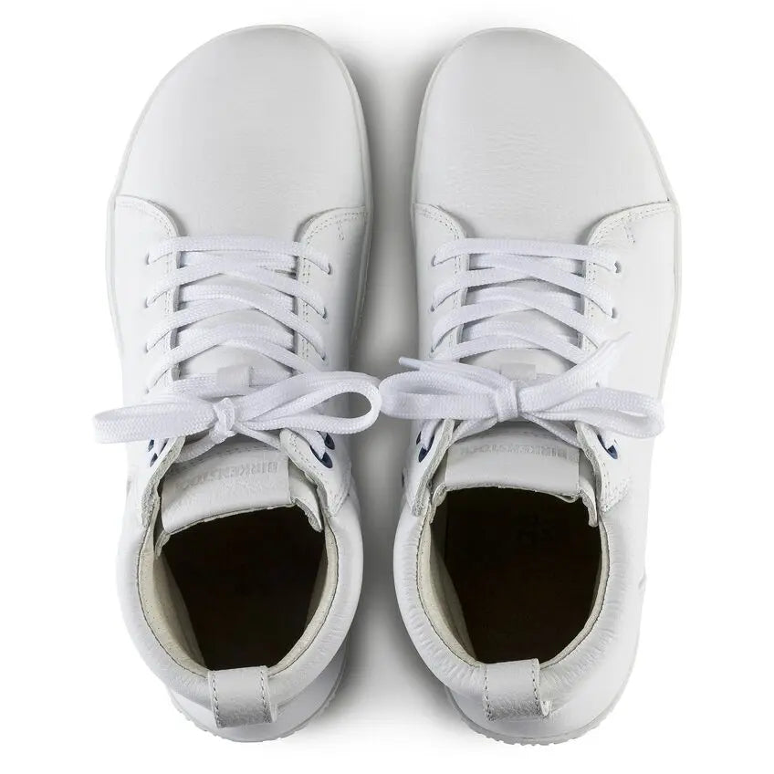 Pair of white leather lace-up sneakers viewed from above on a plain background