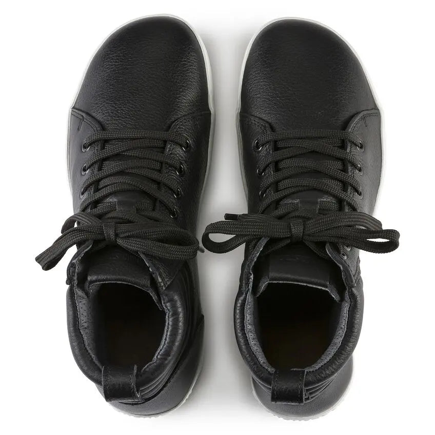 Pair of black leather lace-up sneakers with white soles, viewed from above