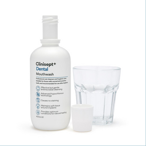 Clinisept+ dental mouthwash in a 400ml bottle with an integrated cup, designed for home oral hygiene use