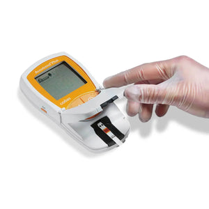 Accutrend Plus medical meter with test strip, gloved hand operating device on white background