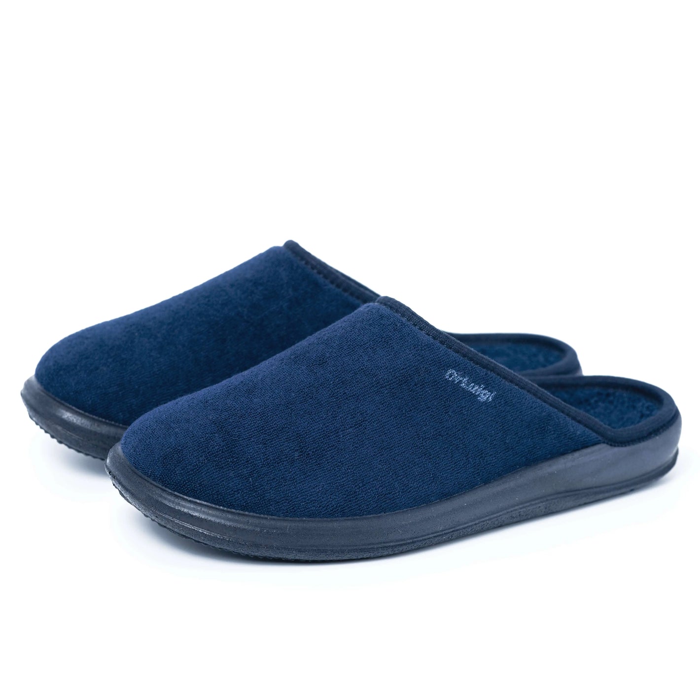Navy blue closed toe comfort slippers with black non-slip soles on white background