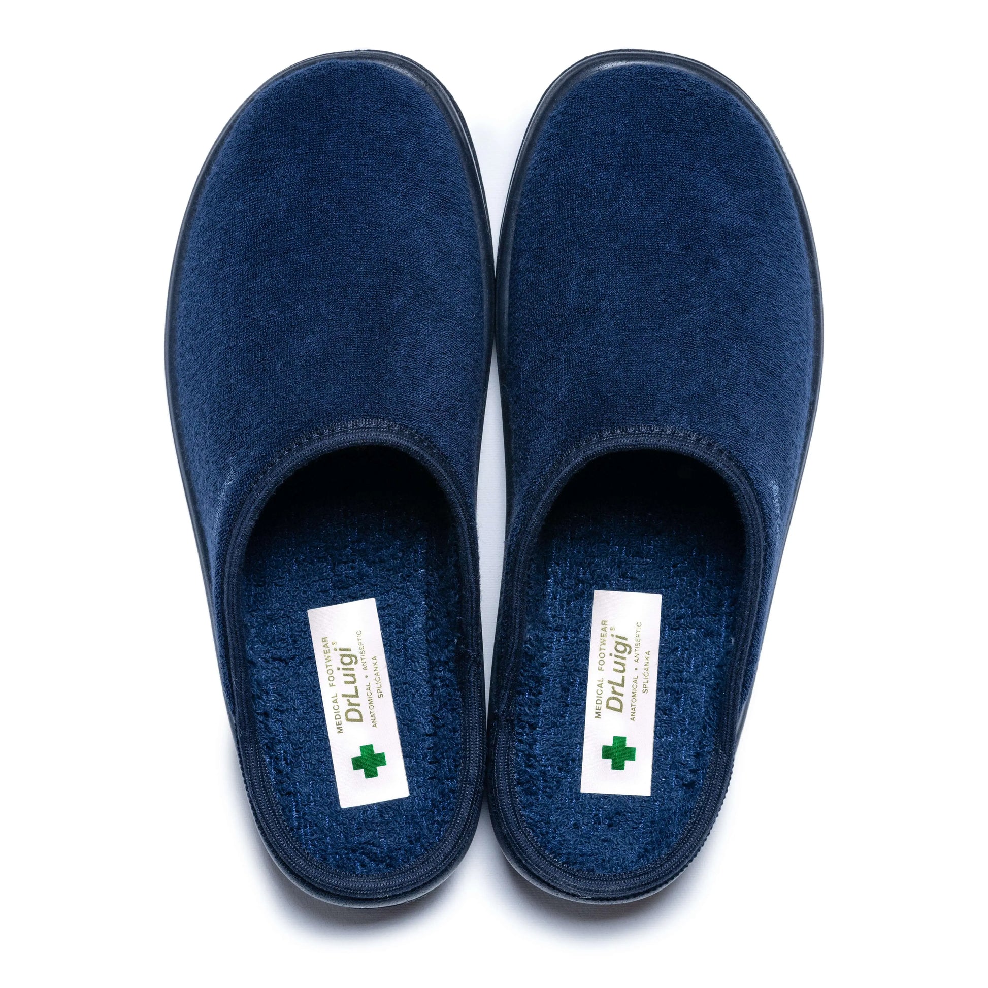 Pair of blue medical slippers with soft fabric and closed toes on white background