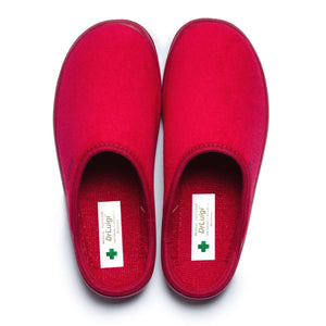 Pair of red medical orthopedic slippers with closed toe on white background