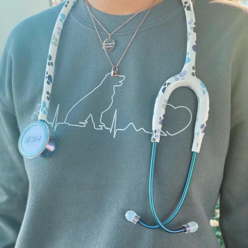 MDF Instruments MD One Epoch Titanium adult stethoscope with Paws design and travel case, featuring silver tubing and ear tips.