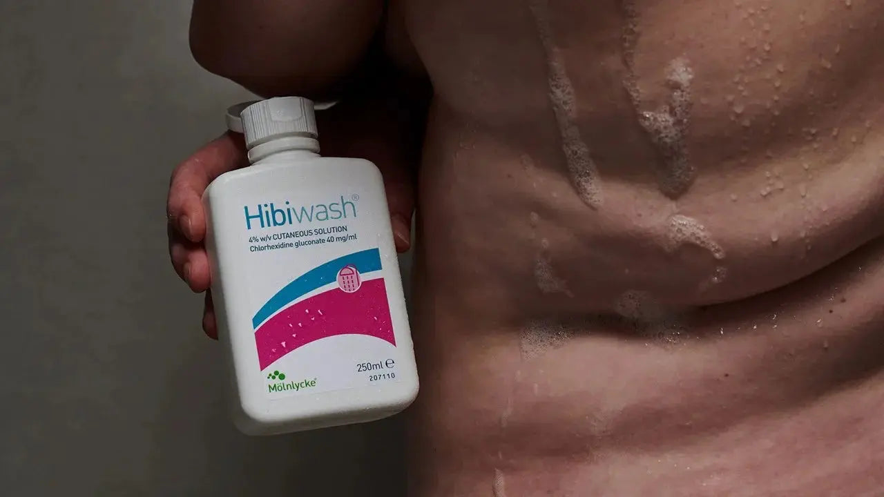 HibiWash antiseptic skin cleansing body wash bottle in a shower setting, 250 ml, by MoInlycke, for hygienic skin care.