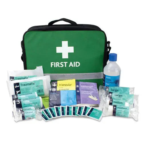 Green first aid kit bag with assorted medical supplies, bandages, gloves, and eyewash bottle