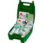 Green first aid kit open with medical supplies including bandages, dressings, gloves, and scissors