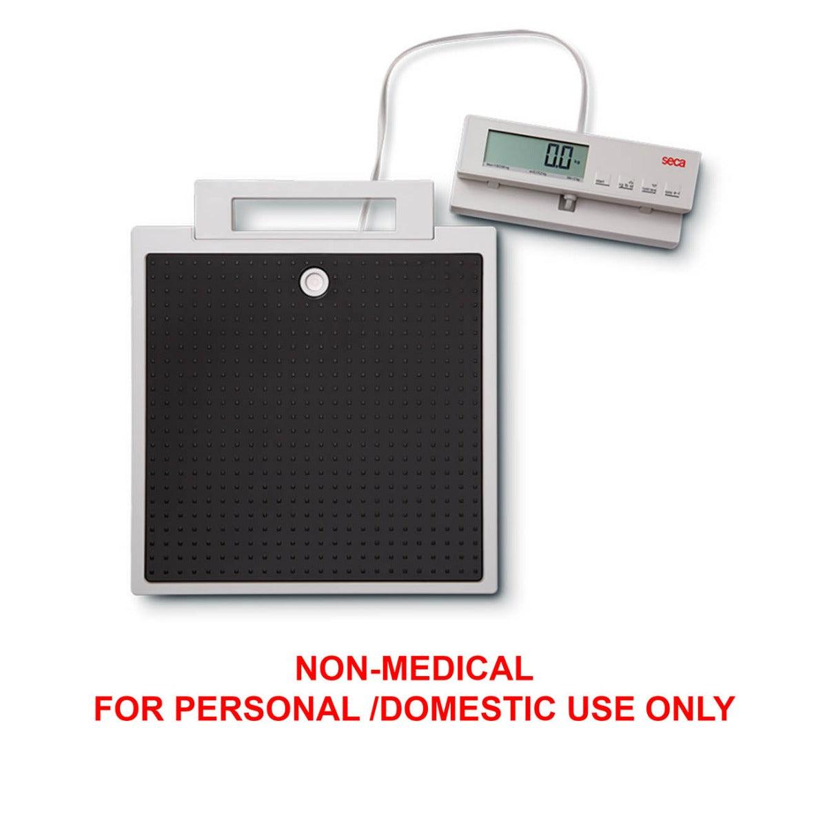 SECA 869 flat scales with cable remote display for non-medical use, featuring a large weighing platform and digital readout.
