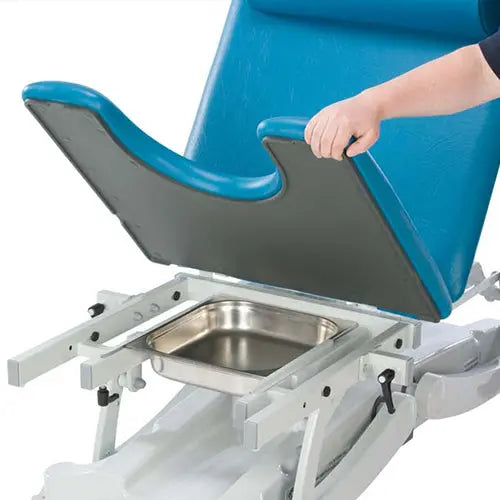 Close-up of adjustable medical chair with blue padded seat and removable stainless pan