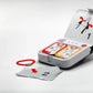 Automated external defibrillator with open lid and electrode pads on white background